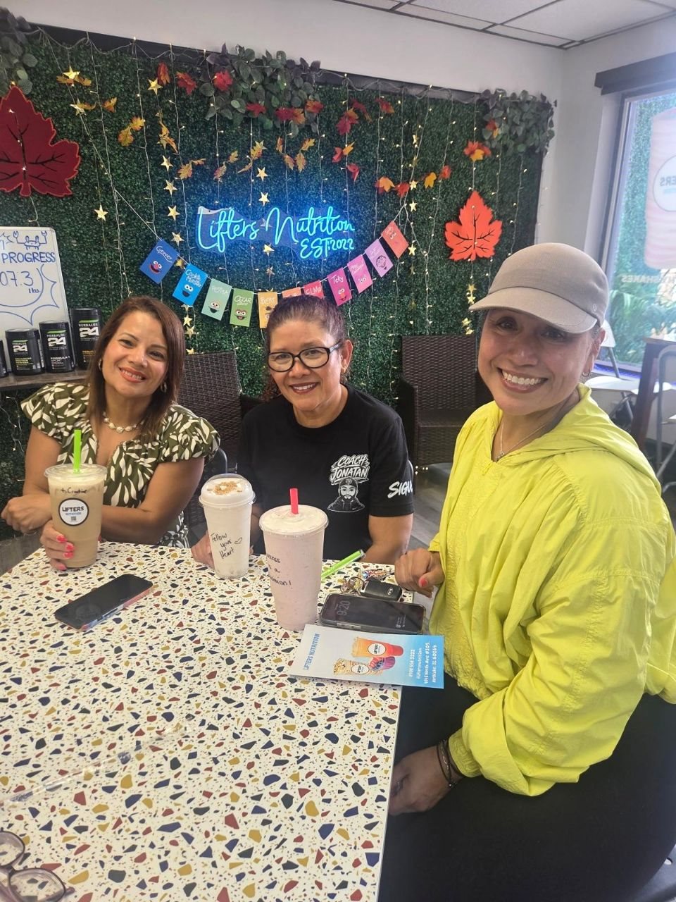 Three friends with Lifters shakes at a table