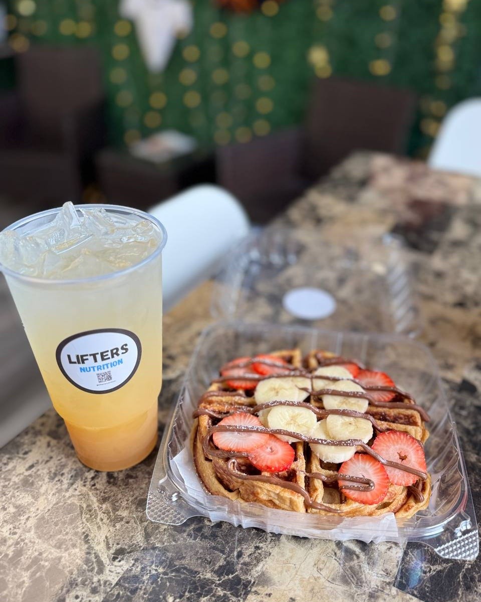 A Lifters refresher next to a protein waffle with strawberries and bananas